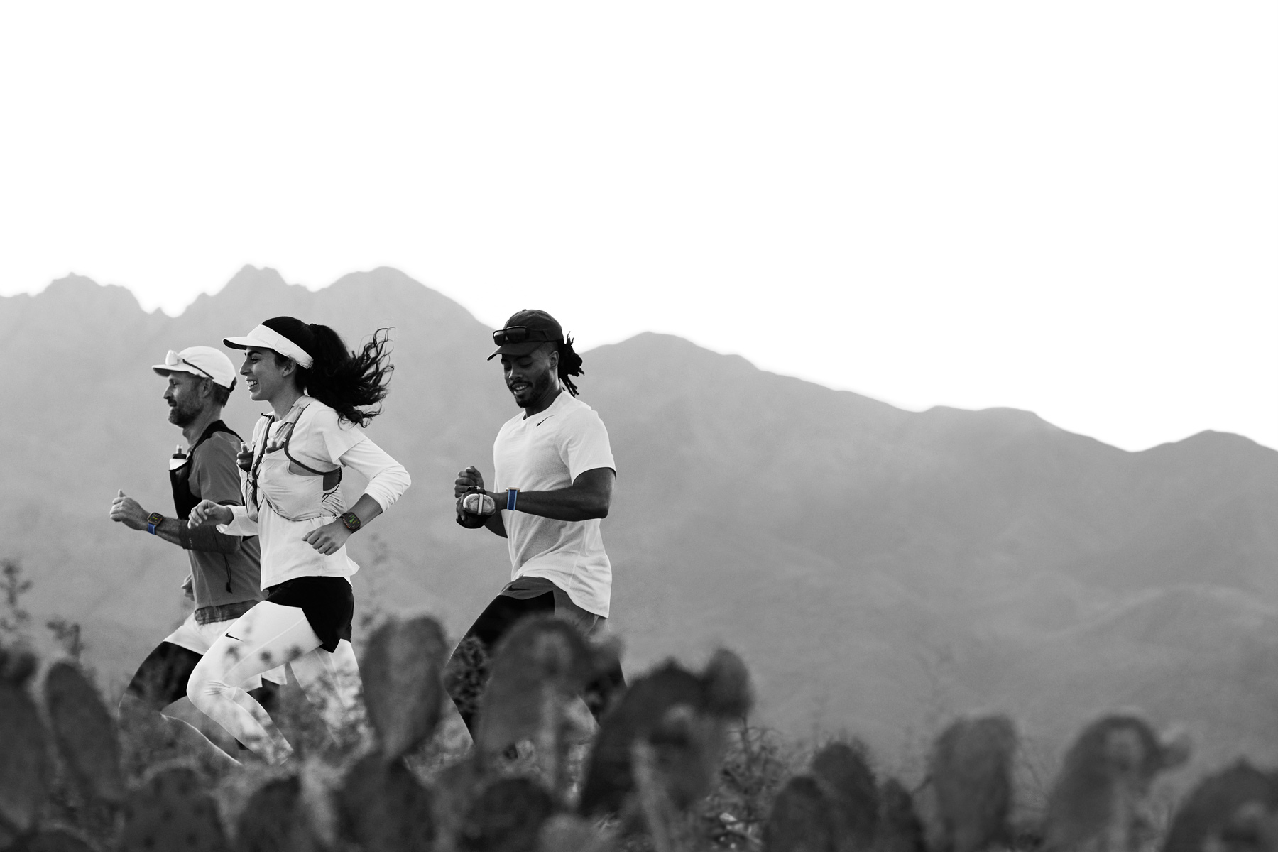 Runners on a desert trail track their workouts on Apple Watch Ultra 3